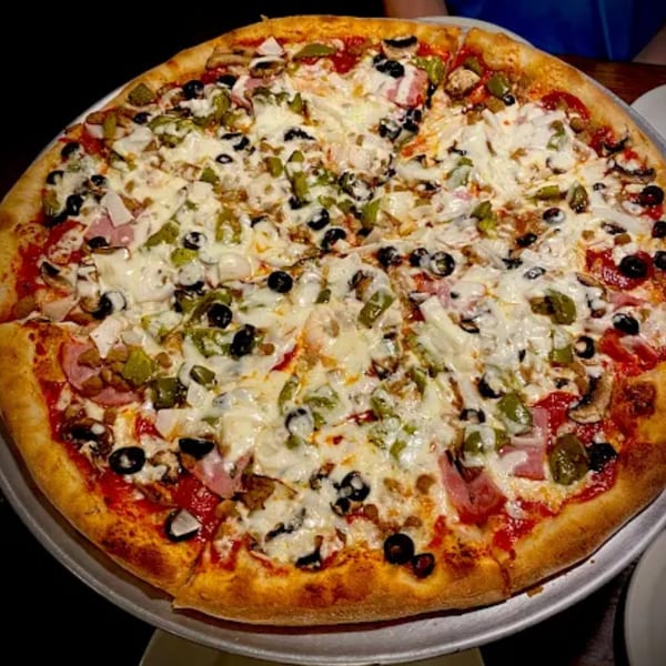 Lizzano's large Italian pizza with ham, green peppers, black olives, and mushrooms.