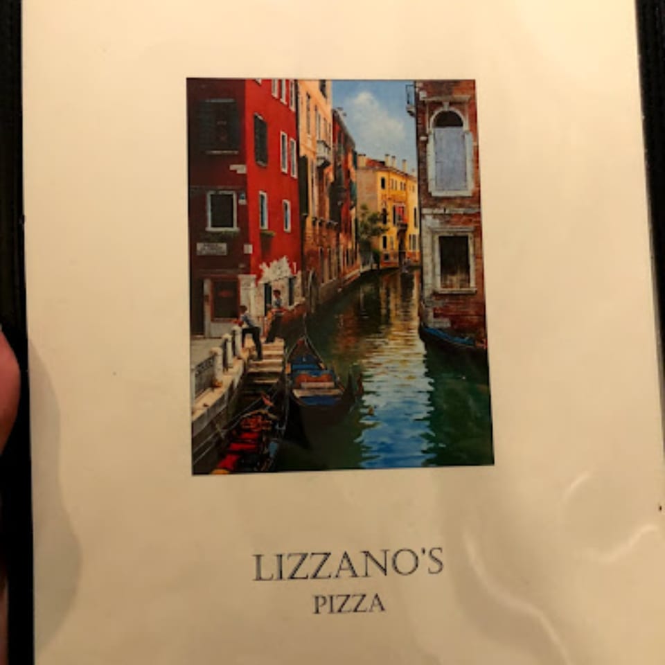 Lizzano's Pizza menu cover with a painting of a Venetian canal scene.