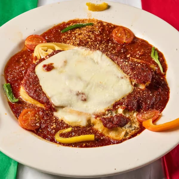 Lizzano's baked ravioli with melted mozzarella, rich red sauce, cherry tomatoes, and peppers.